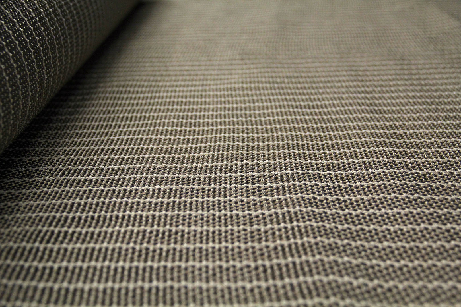 A close up of the fabric on a carpet.